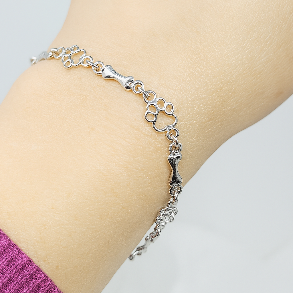 Polsera amb charms de peu i osseta de plata