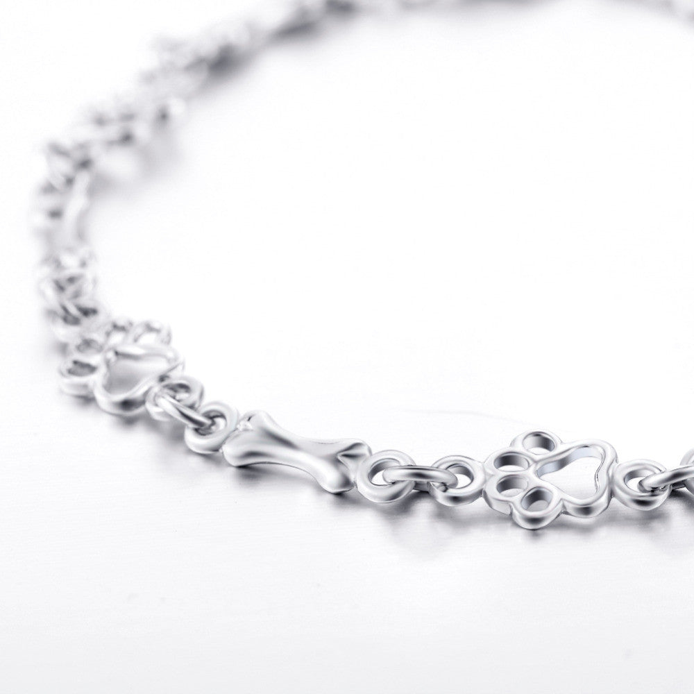 Bracelet avec breloques empreinte et os en argent