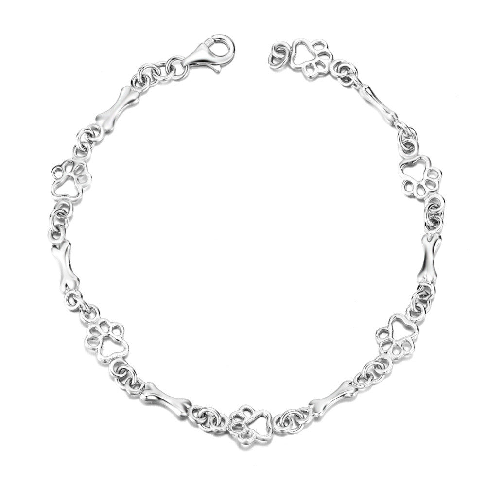 Polsera amb charms de peu i osseta de plata
