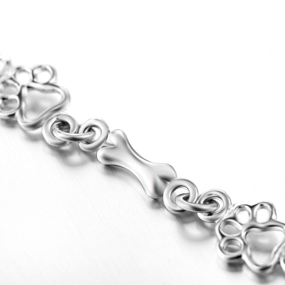 Bracelet avec breloques empreinte et os en argent