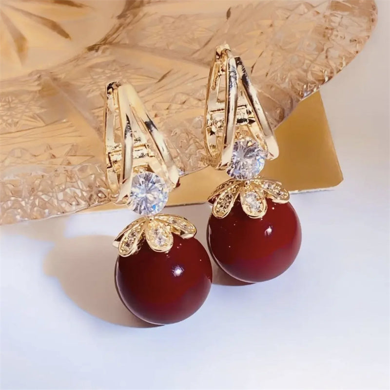 Arracades llargues de perles brillants per a dona